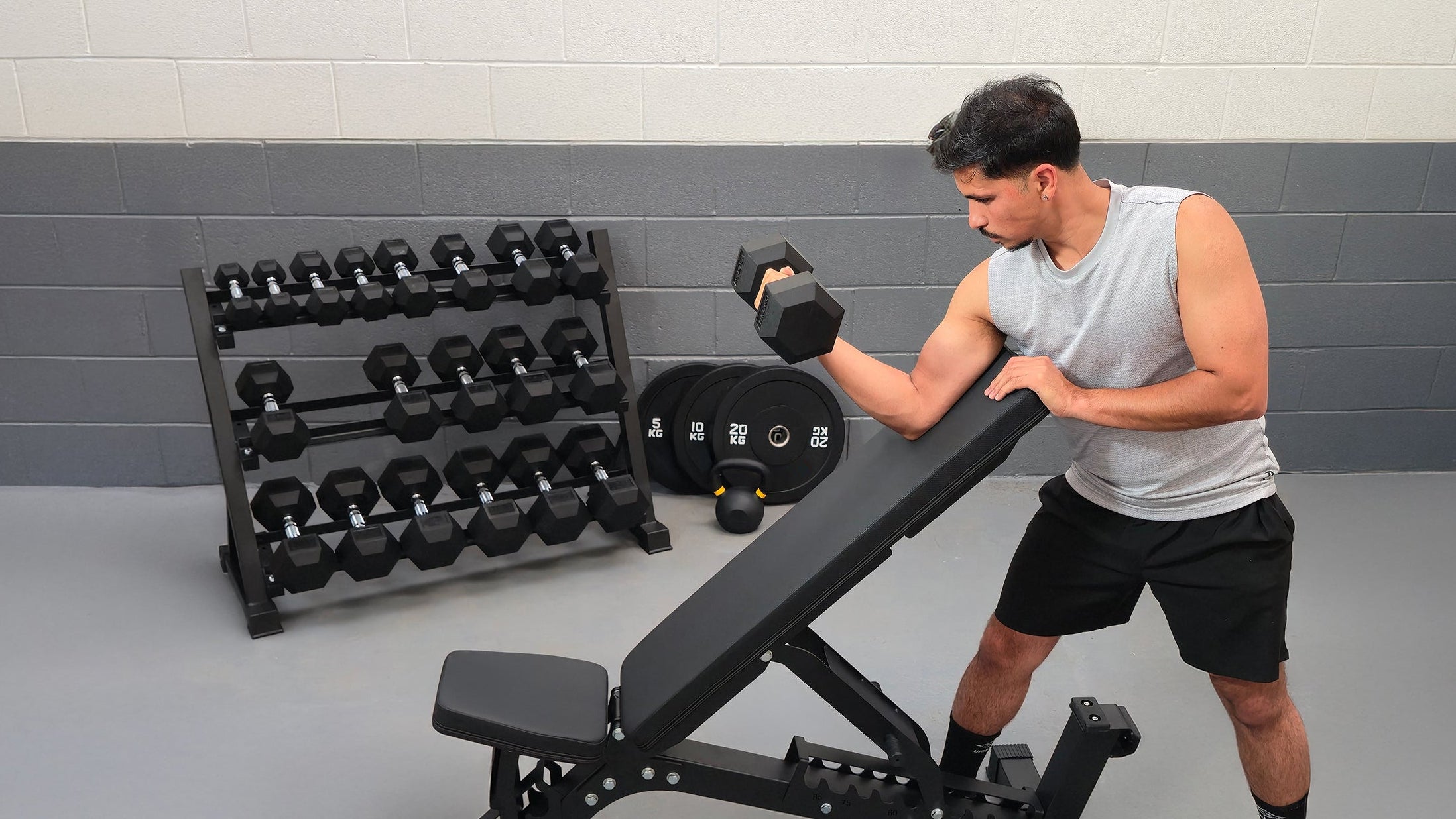 Man exercising with a weight bench in a gym setting